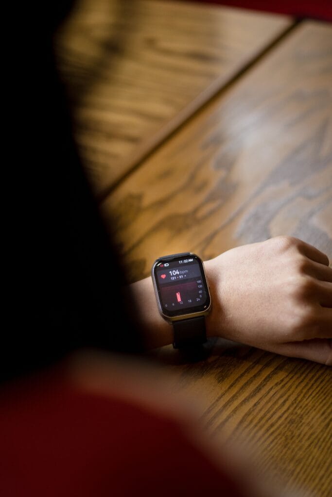 Person checking a pulse reading on a smartwatch during symptoms of dizziness or blackouts.