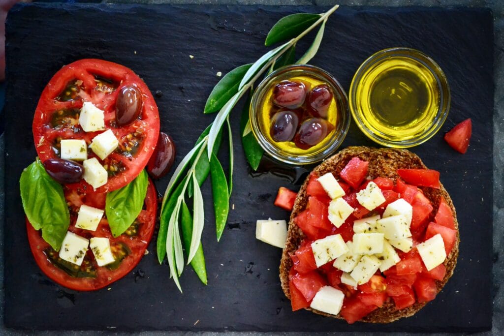 Mediterranean-style tomato salad with olives, olive oil, basil and wholegrain bread.