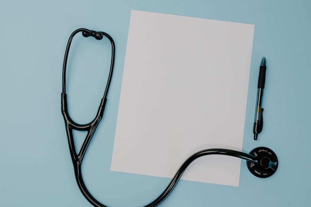 Black stethoscope on a white sheet of paper for heart murmur assessment.